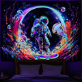 A vibrant UV-reactive blacklight tapestry featuring an astronaut on a skateboard surrounded by glowing neon jellyfish and a colorful ringed planet in a deep space setting.